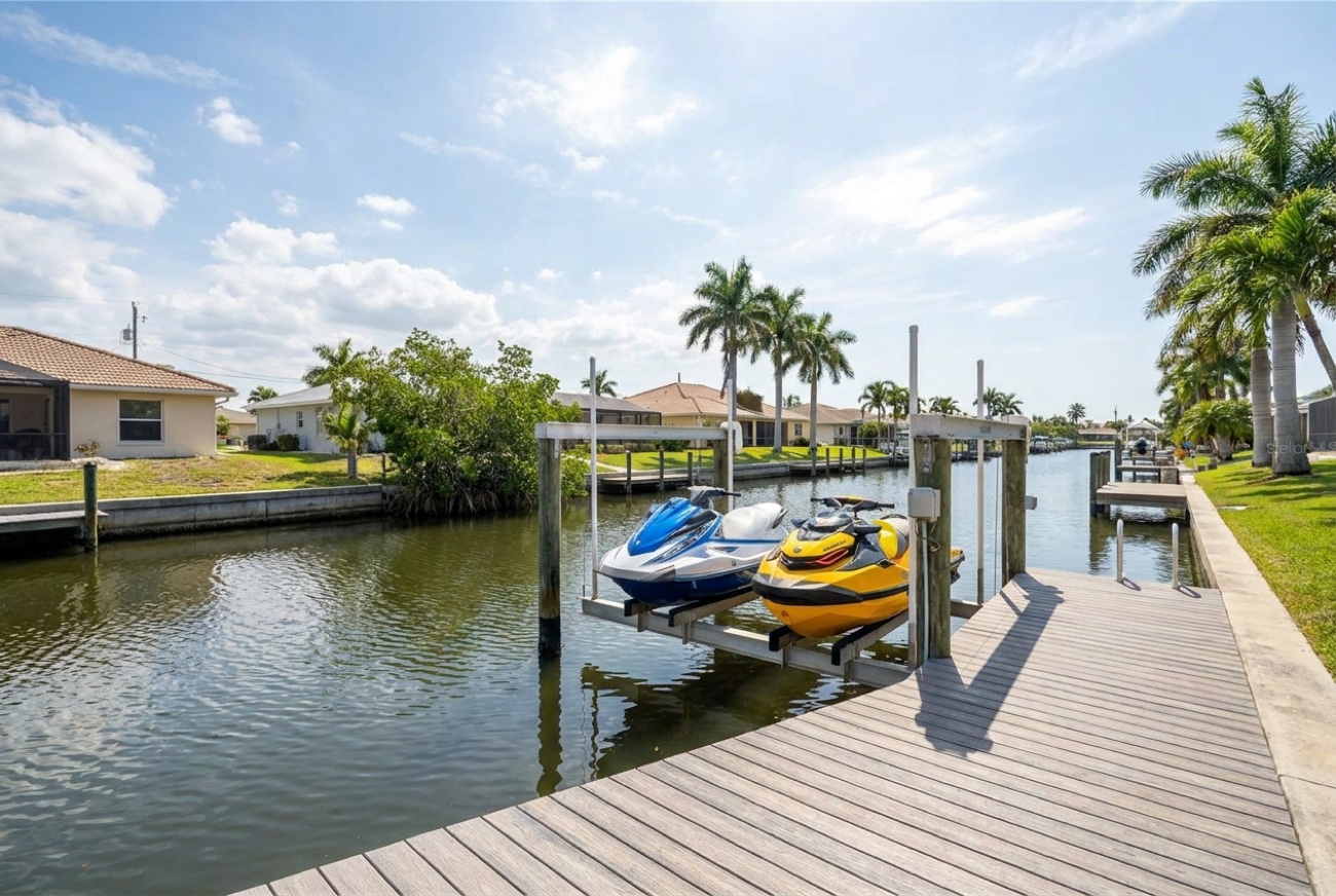 Jet ski / PWC lift beside a composite dock on a Cape Coral canal